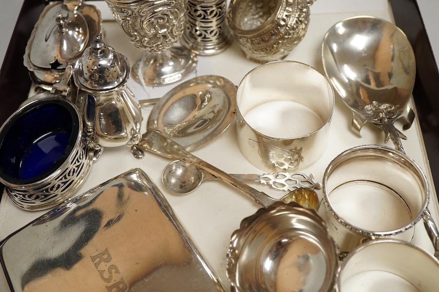 A collection of silver to inlcude a George V cigarette case, Victorian and later cruet items, assorted napkin rings etc. various, weighable silver approx. 18.4ozt